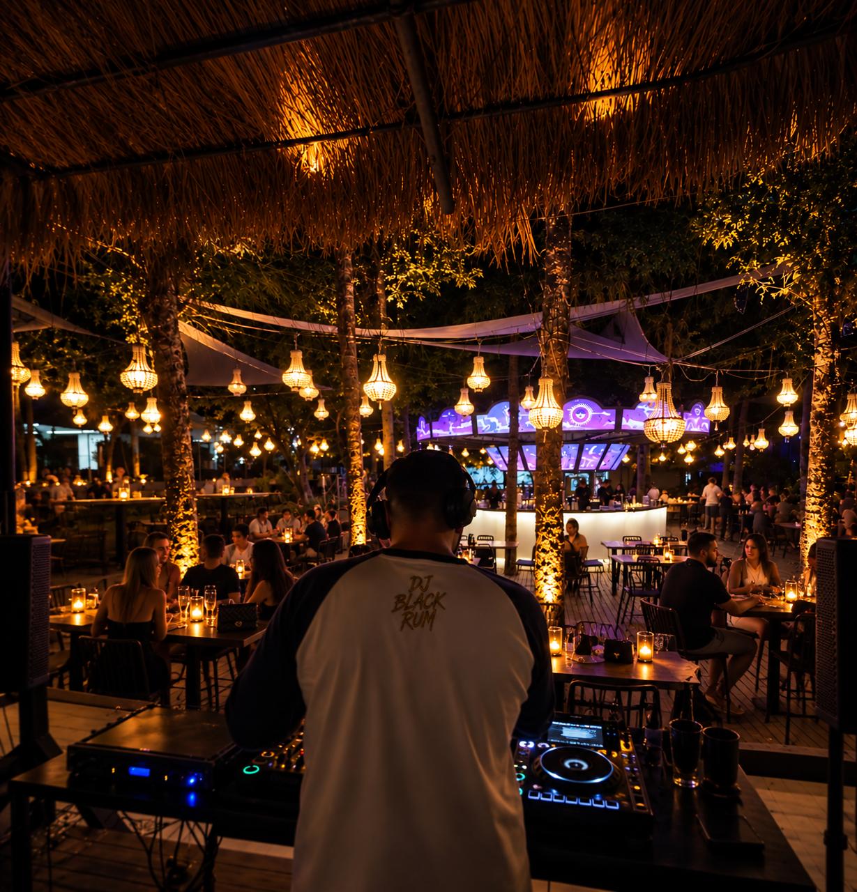DJ Black Rum la mixer, cu terasa luminată în fundal